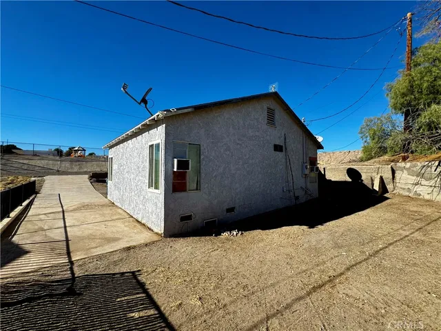 a black car parked in front of a house