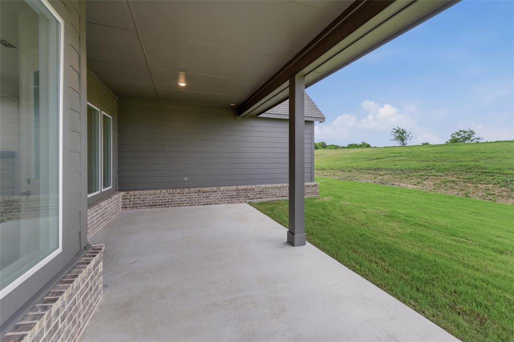119 Hillview Trail Decatur, TX 76234 - Photo 25 of 30 Concrete patio with a dark grey column and matching overhead structure