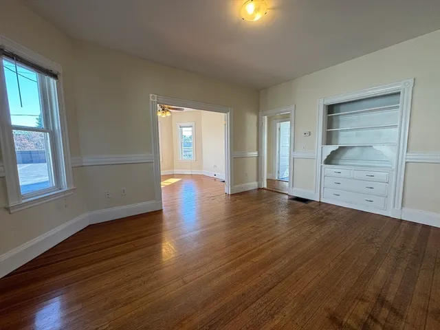 wooden floor in an empty room with a window