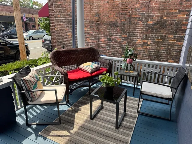 a view of a chairs and table in the balcony