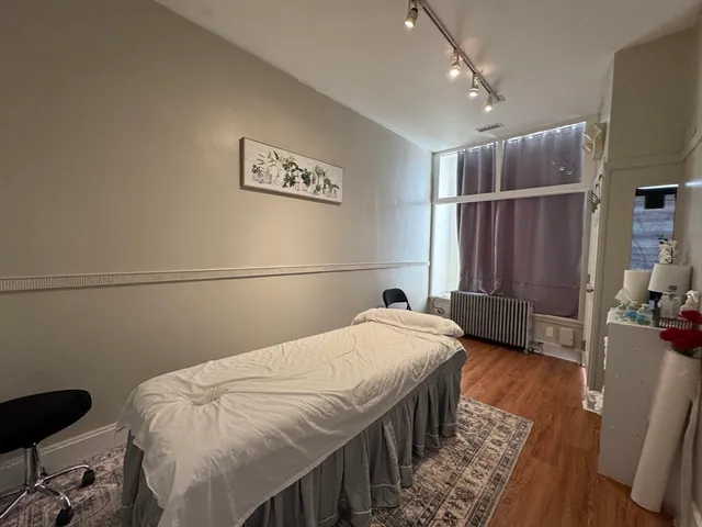 a bedroom with a bed and a desk in it
