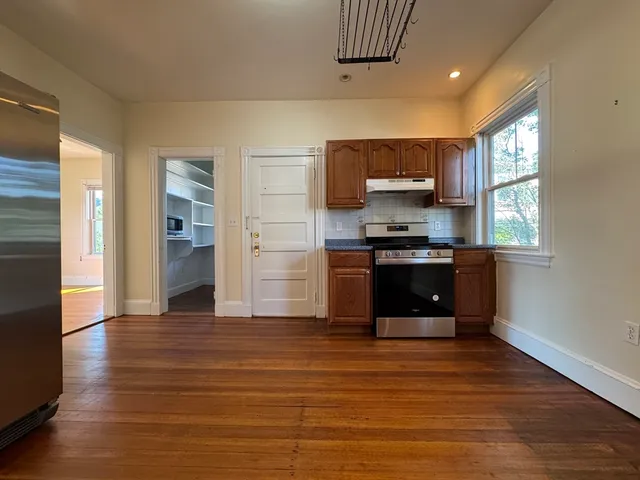 a kitchen with stainless steel appliances granite countertop a stove and a refrigerator
