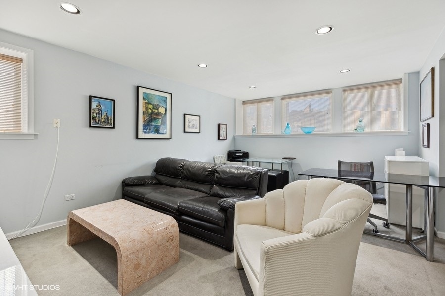 Undisclosed Address Chicago, IL 60657 - Photo 12 of 40 a living room with furniture and a wooden floor