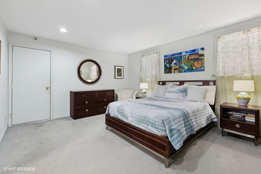 Undisclosed Address Chicago, IL 60657 - Photo 15 of 40 a spacious bedroom with a bed and a chandelier