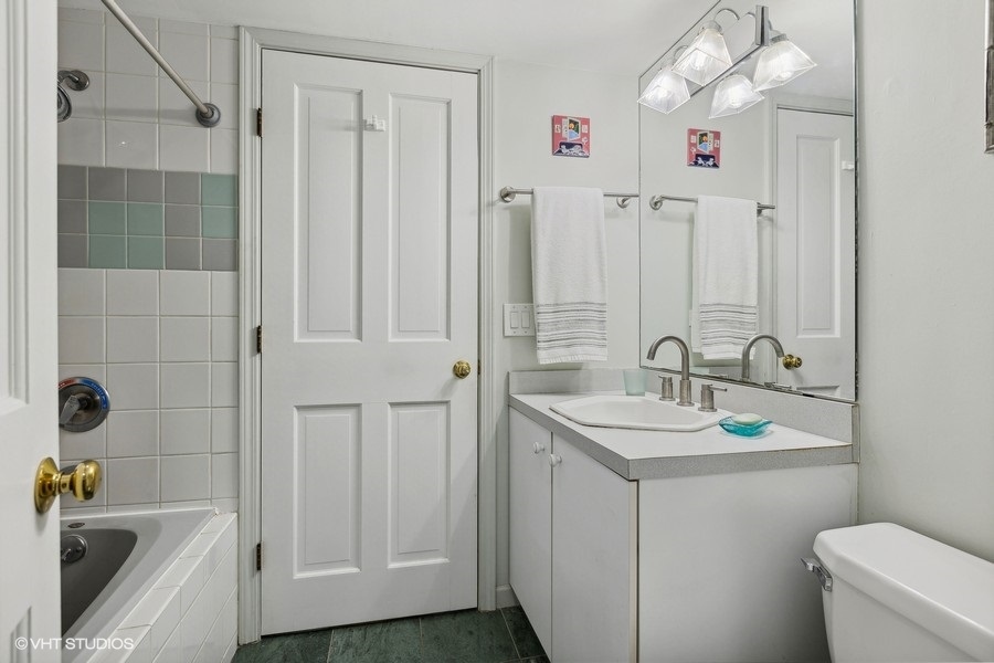 Undisclosed Address Chicago, IL 60657 - Photo 16 of 40 a bathroom with a sink a toilet and shower
