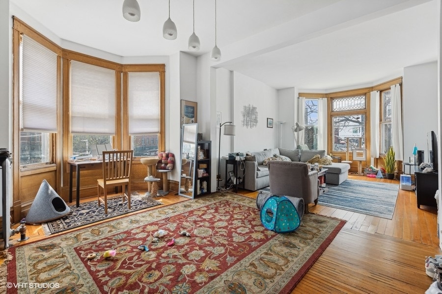 Undisclosed Address Chicago, IL 60657 - Photo 18 of 40 a living room with furniture city view and large windows