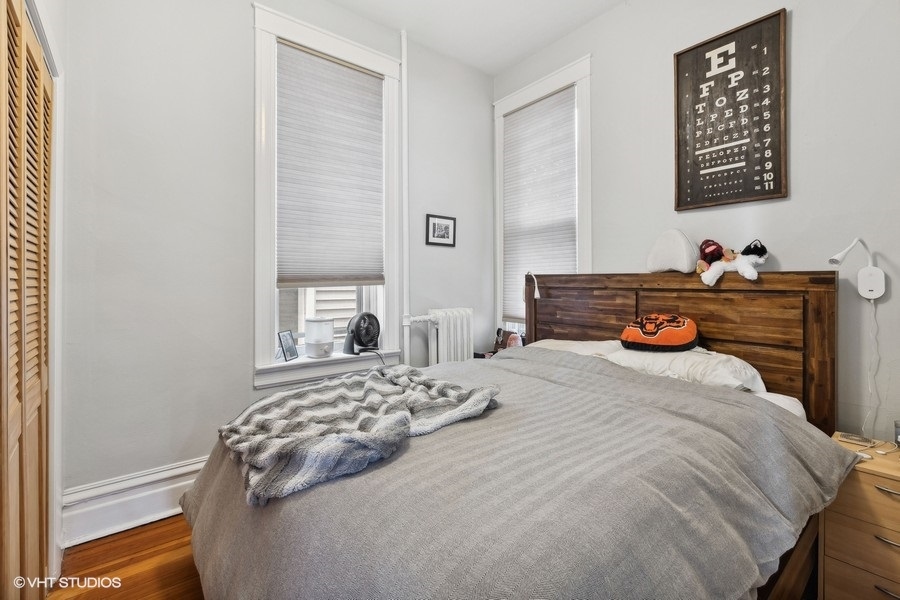 Undisclosed Address Chicago, IL 60657 - Photo 22 of 40 a bedroom with a bed and a dresser