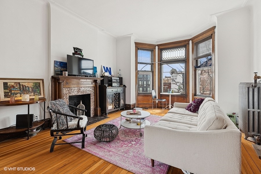 Undisclosed Address Chicago, IL 60657 - Photo 23 of 40 a living room with furniture a flat screen tv and a fireplace