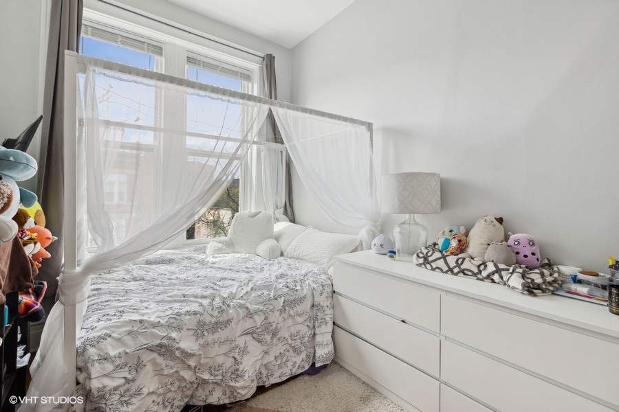 Undisclosed Address Chicago, IL 60657 - Photo 28 of 40 a bedroom with a bed and a window