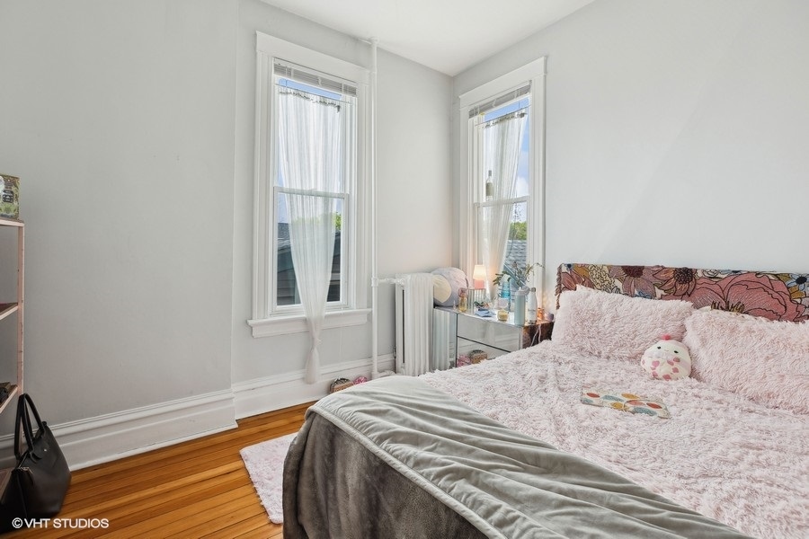 Undisclosed Address Chicago, IL 60657 - Photo 30 of 40 a bedroom with a bed and a window