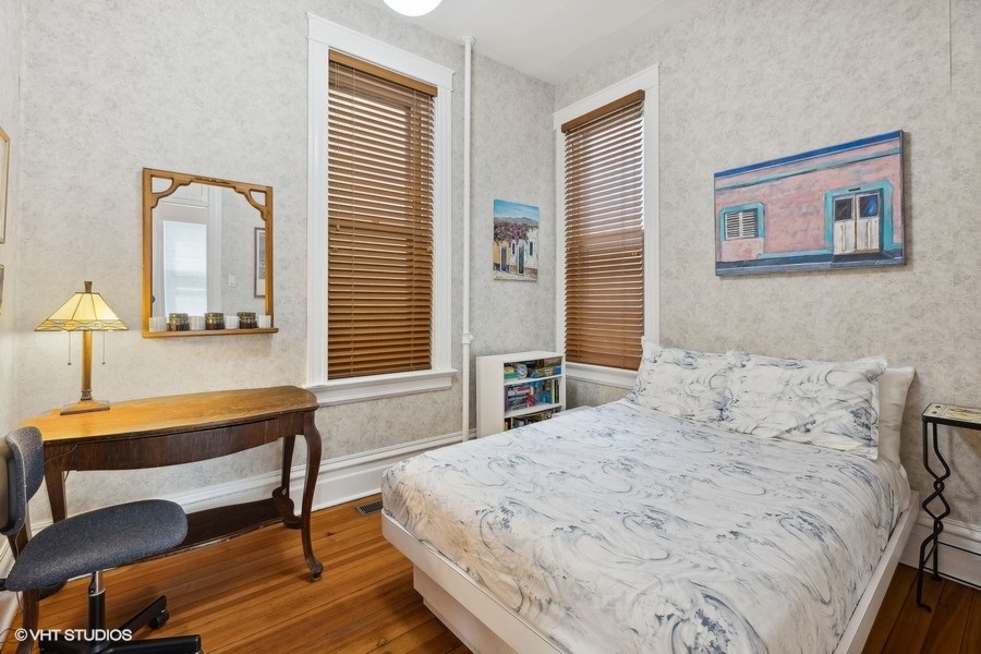 Undisclosed Address Chicago, IL 60657 - Photo 6 of 40 a bedroom with a bed and a table in it