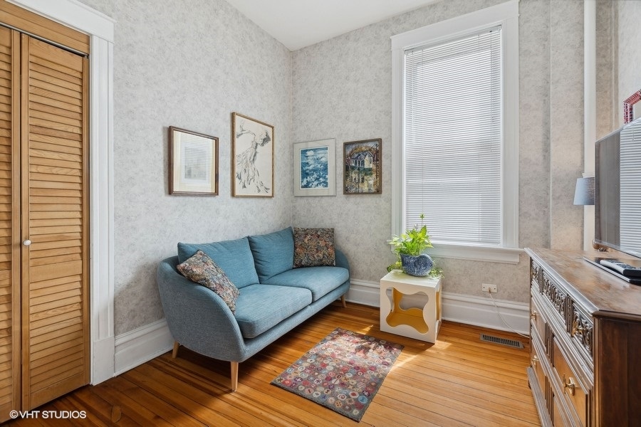 Undisclosed Address Chicago, IL 60657 - Photo 9 of 40 a living room with furniture and a fireplace