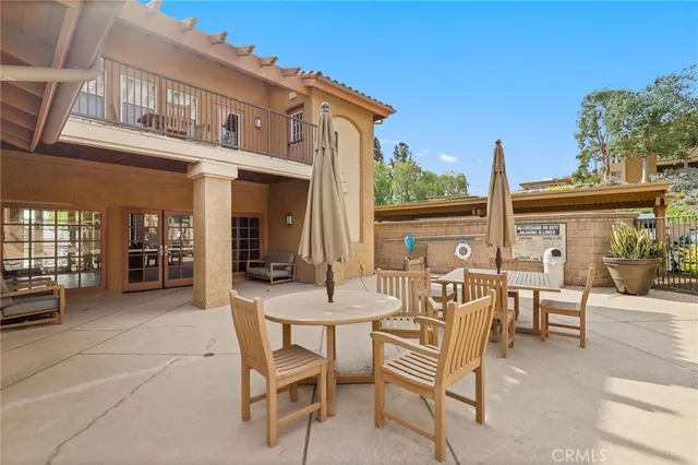 a view of a patio with table and chairs and potted plants
