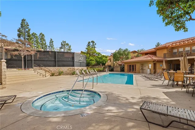 a swimming pool with outdoor seating and a patio