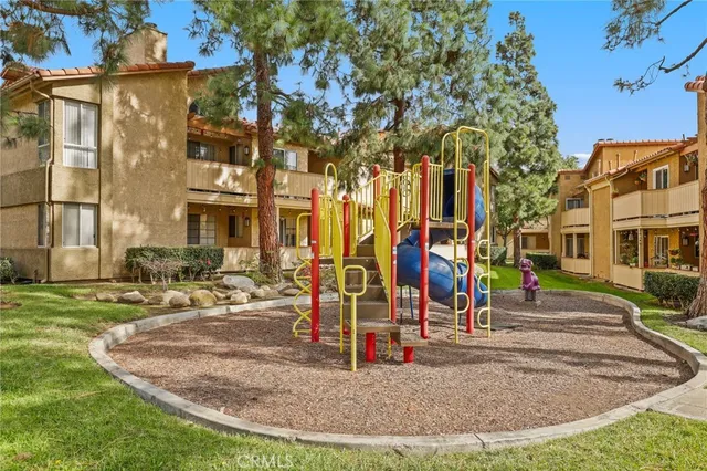 a view of a park with swings and slides