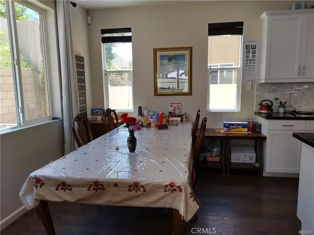 a kitchen with a table chairs and a window