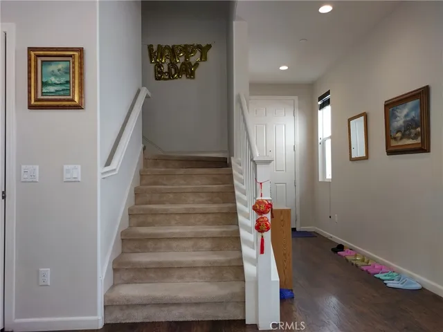 a view of a workspace room with wooden floor and hallway