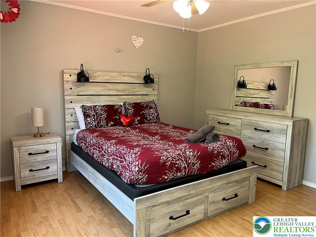 1646 Clover Road Long Pond, PA 18334 - Photo 14 of 24 Gleaming wood floors pair perfectly with clean crown molding in this restful space.