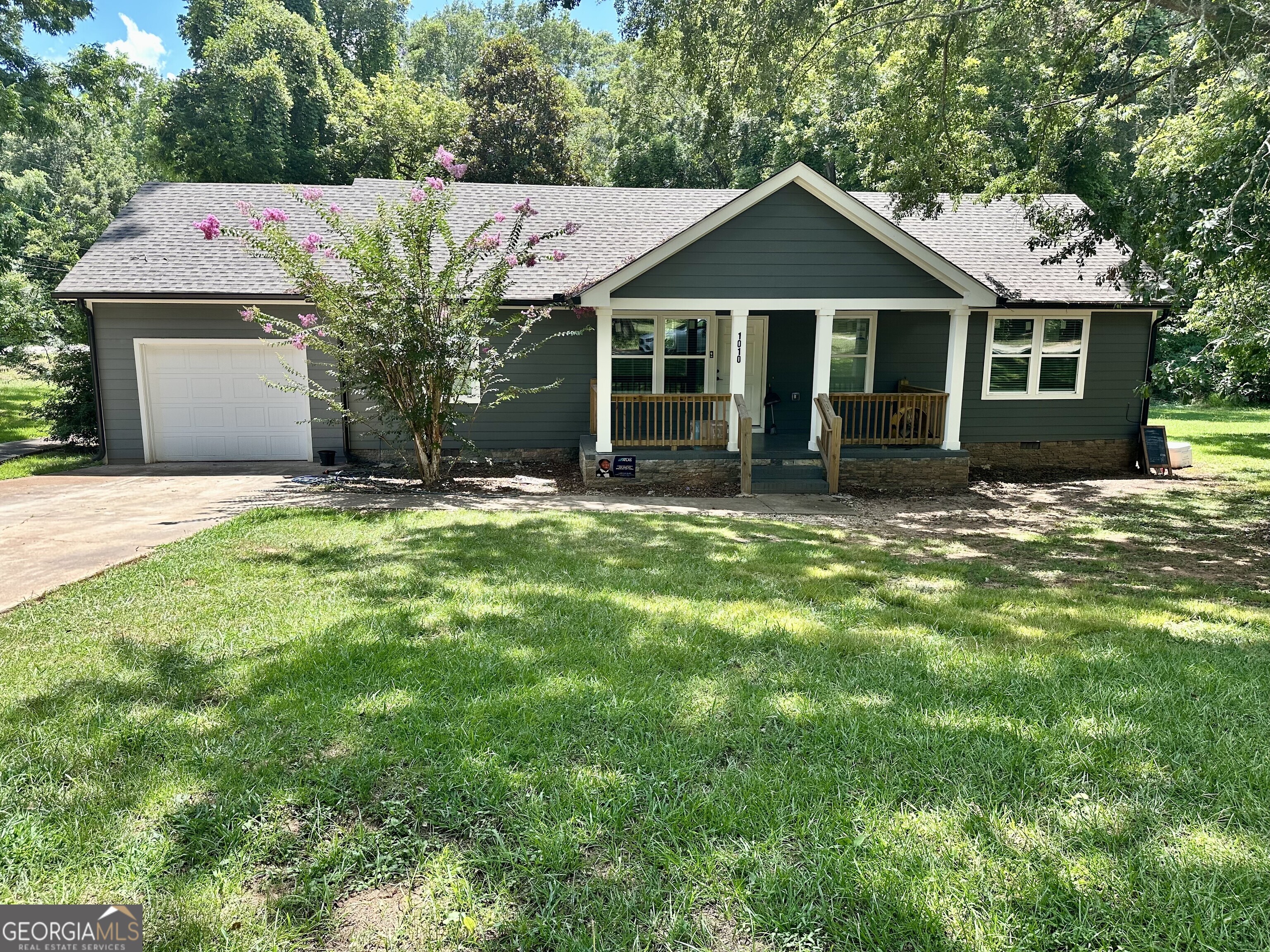 1010 Orear Road Union Point, GA 30669 - Photo 1 of 1 a front view of a house with a garden and trees