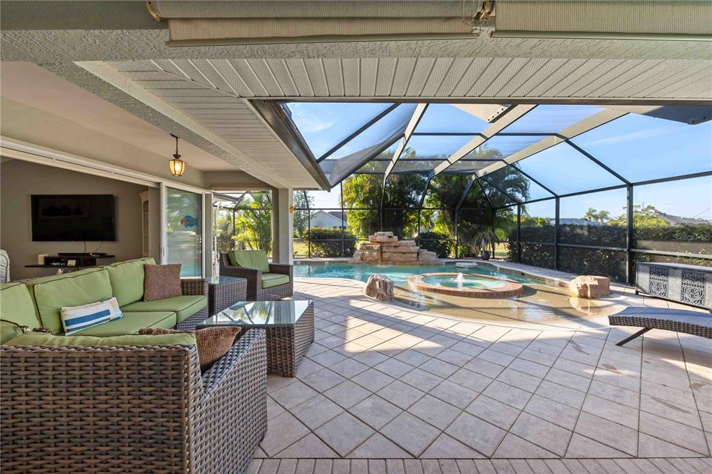 175 Rotonda Boulevard North Rotonda West, FL 33947 - Photo 18 of 33 a living room with a couch and a flat screen tv