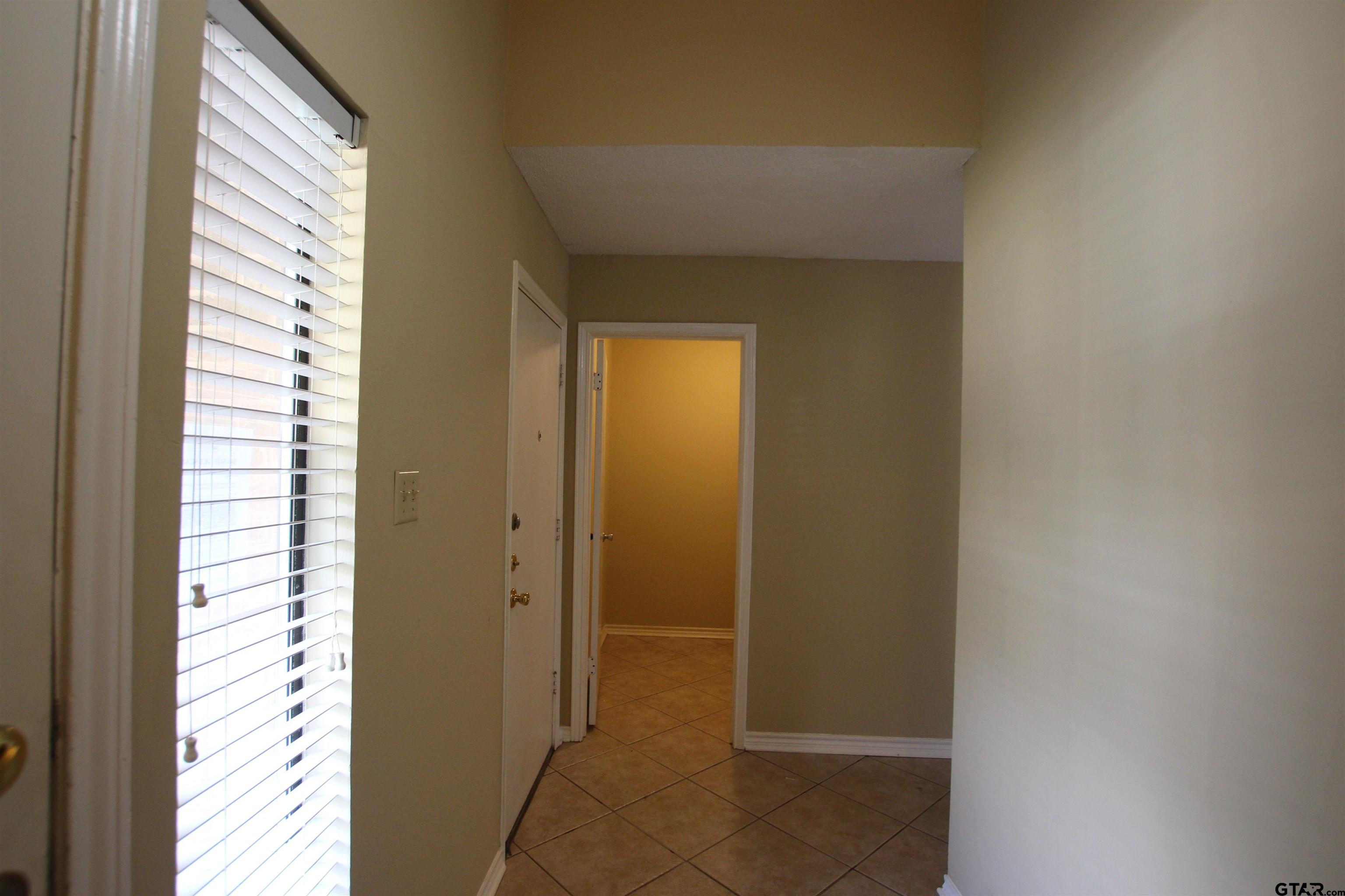 5875 Creekside Circle Tyler, TX 75703 - Photo 4 of 32 a view of a bathroom from a hallway