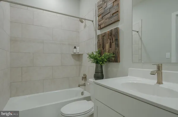 a bathroom with a sink a toilet and bathtub