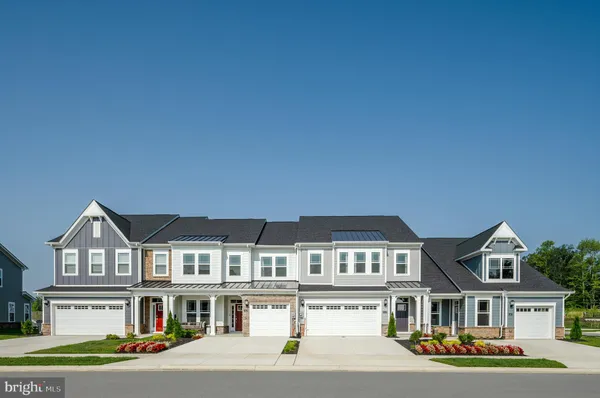 a front view of residential houses with street