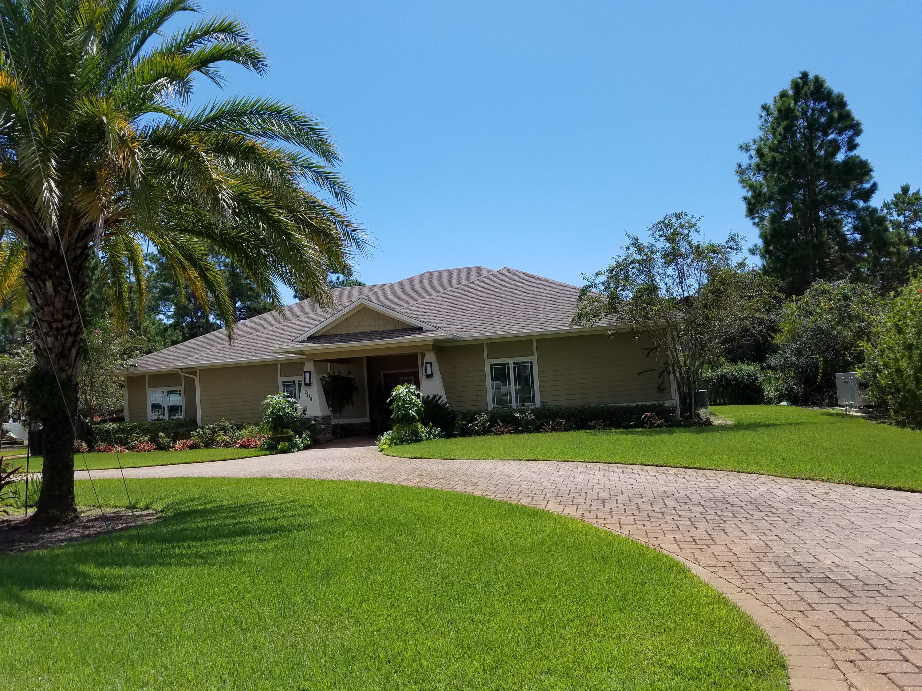 Lot 16 Ridge Road Santa Rosa Beach, FL 32459 - Photo 12 of 12 a front view of a house with a garden and trees