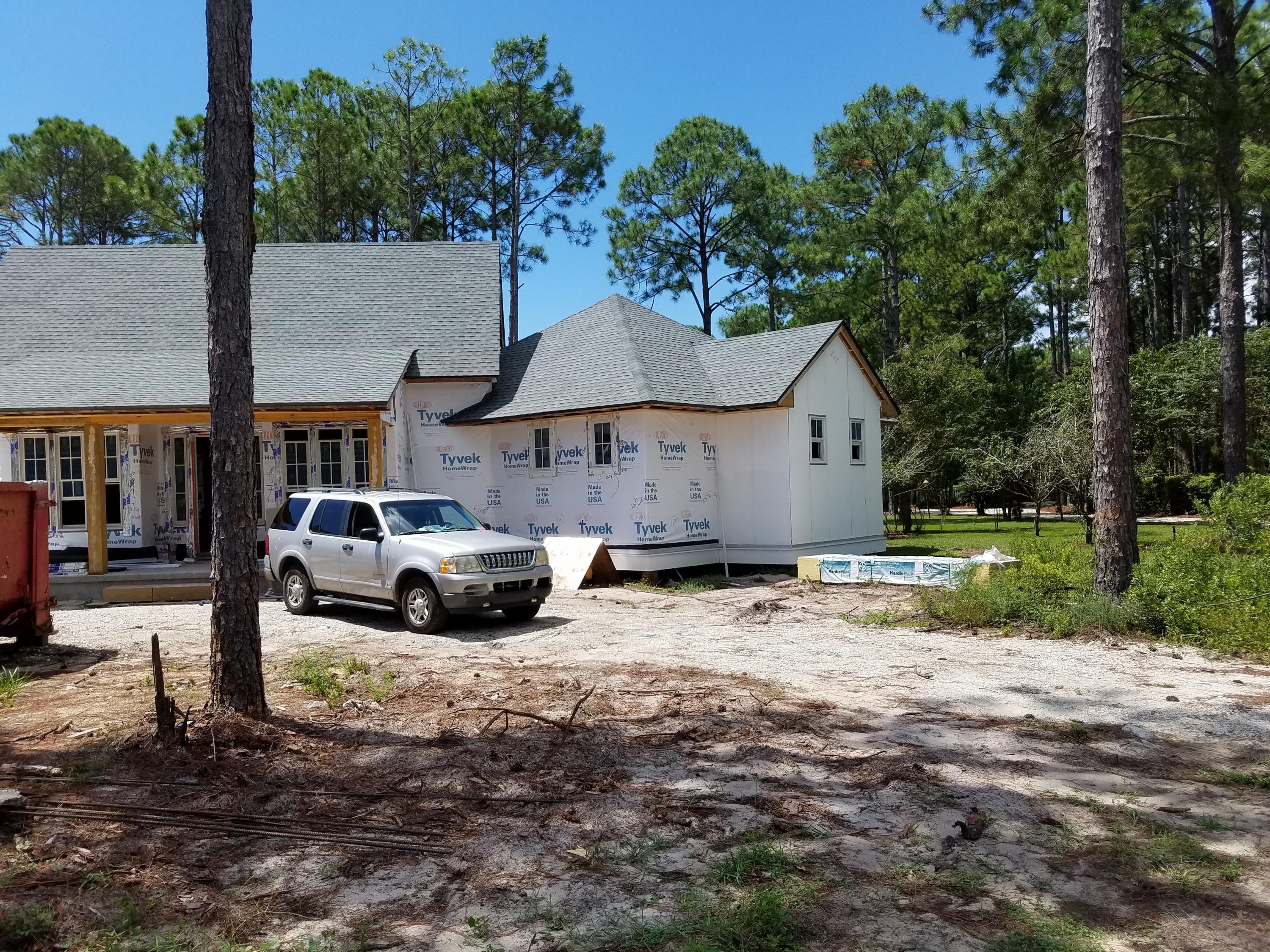 Lot 16 Ridge Road Santa Rosa Beach, FL 32459 - Photo 10 of 12 a front view of a house with a yard and garage