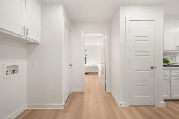a view of a hallway with wooden floor