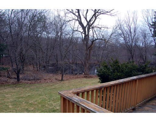 251 Highland Road Andover, MA 01810 - Photo 17 of 19 a view of wooden fence and trees in the background