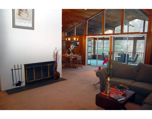 251 Highland Road Andover, MA 01810 - Photo 4 of 19 a living room with furniture a flat screen tv and floor to ceiling window