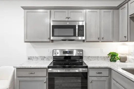 940 Britton Springs Road, Unit 203 Clarksville, TN 37042 - Photo 11 of 30 a kitchen with stainless steel appliances granite countertop white cabinets and a stove top oven