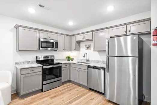 940 Britton Springs Road, Unit 203 Clarksville, TN 37042 - Photo 10 of 30 a kitchen with white cabinets stainless steel appliances and a refrigerator