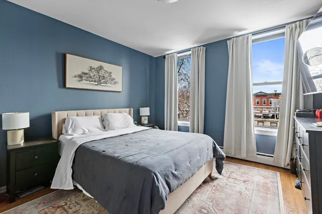 a bedroom with a large bed and a window