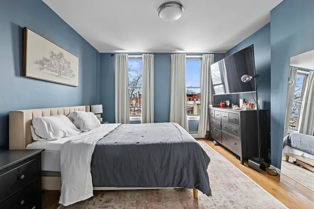 a bedroom with a large bed and a tv