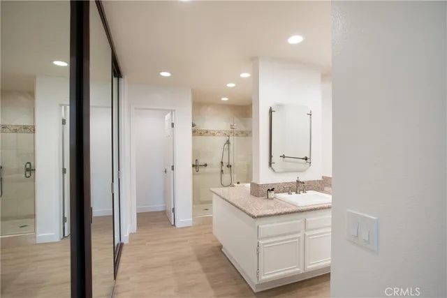 a bathroom with a double vanity sink and a mirror
