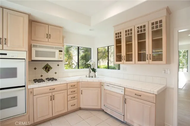 a kitchen with cabinets appliances and a window