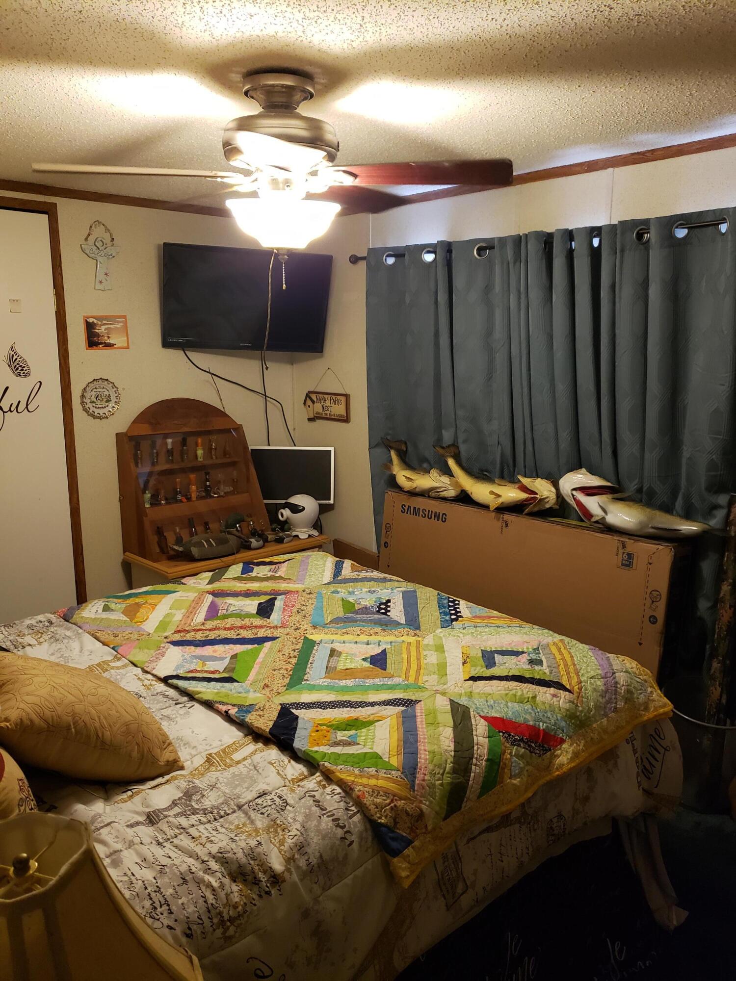 290 Beck Bridge Road Westville, FL 32464 - Photo 12 of 13 a bedroom with a bed and a flat tv screen