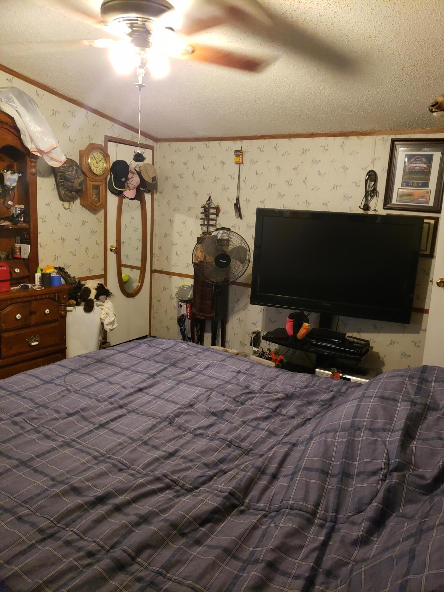 290 Beck Bridge Road Westville, FL 32464 - Photo 10 of 13 a bedroom with a bed and a flat tv screen on the dresser