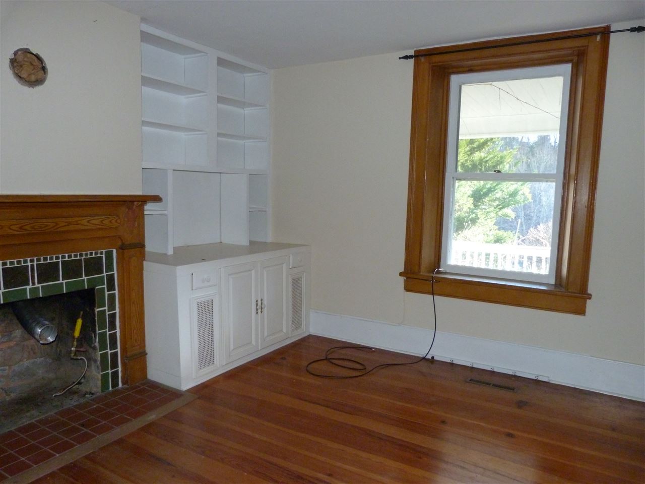 699 Roman Road Mount Sidney, VA 24467 - Photo 6 of 18 a view of an empty room with wooden floor and a window