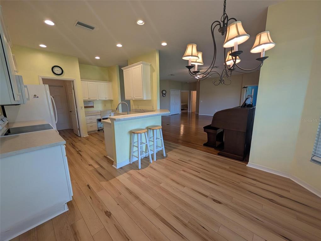 4124 Muirfield Loop Lake Wales, FL 33859 - Photo 11 of 29 a view of a dining room with furniture a chandelier and wooden floor