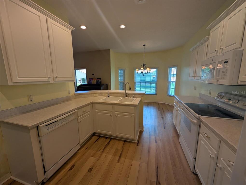 4124 Muirfield Loop Lake Wales, FL 33859 - Photo 14 of 29 a kitchen with a sink stove and cabinets