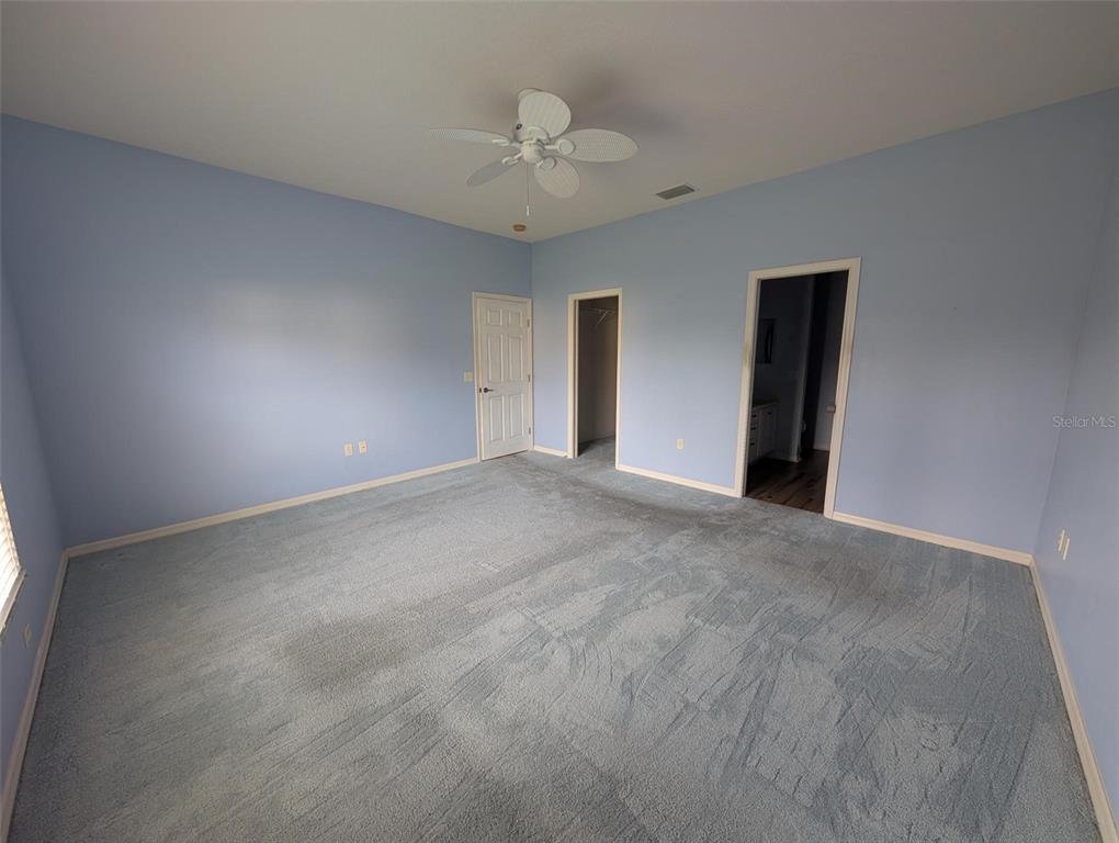 4124 Muirfield Loop Lake Wales, FL 33859 - Photo 18 of 29 a view of an empty room with a chandelier fan