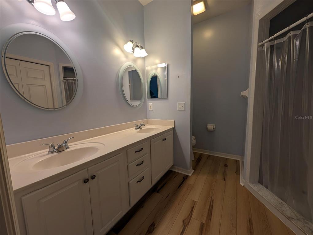 4124 Muirfield Loop Lake Wales, FL 33859 - Photo 19 of 29 a spacious bathroom with a double vanity sink a large mirror and a shower