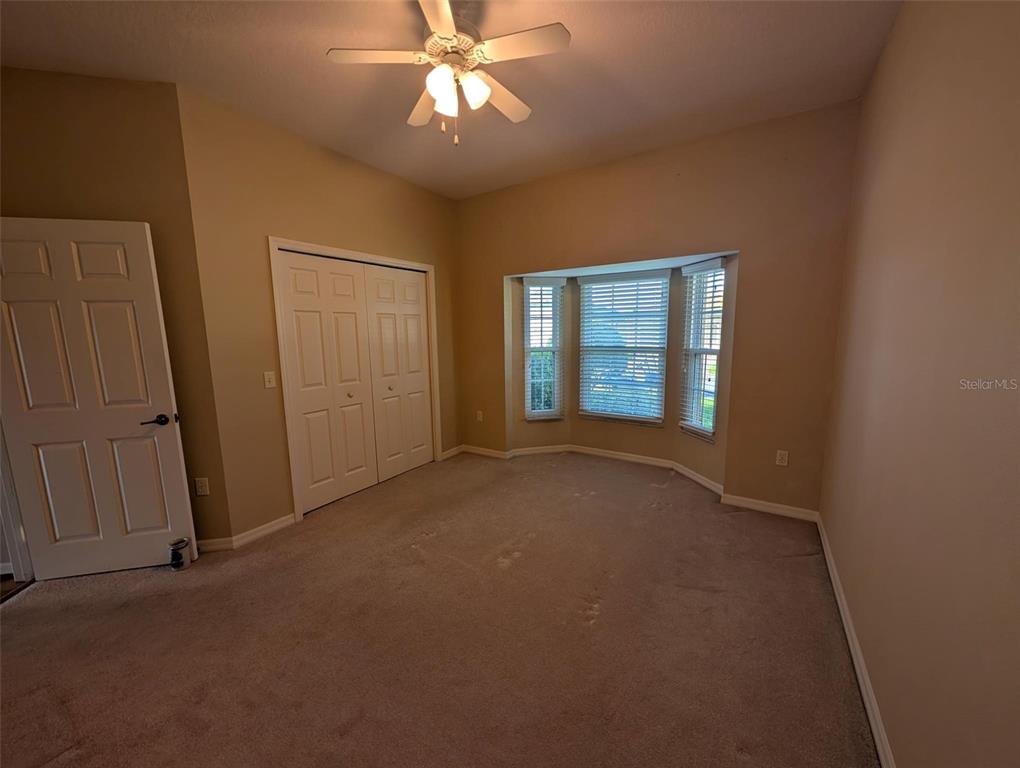 4124 Muirfield Loop Lake Wales, FL 33859 - Photo 22 of 29 an empty room with windows and fan
