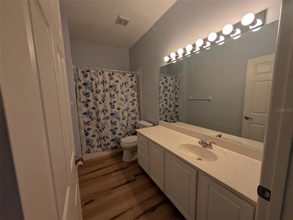 4124 Muirfield Loop Lake Wales, FL 33859 - Photo 24 of 29 a bathroom with a sink a large mirror and shower