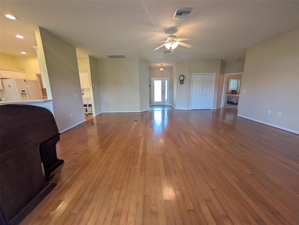 4124 Muirfield Loop Lake Wales, FL 33859 - Photo 4 of 29 a view of empty room with wooden floor and fan