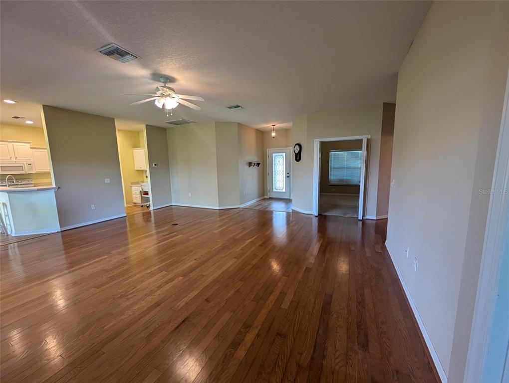 4124 Muirfield Loop Lake Wales, FL 33859 - Photo 5 of 29 wooden floor in an empty room with a window
