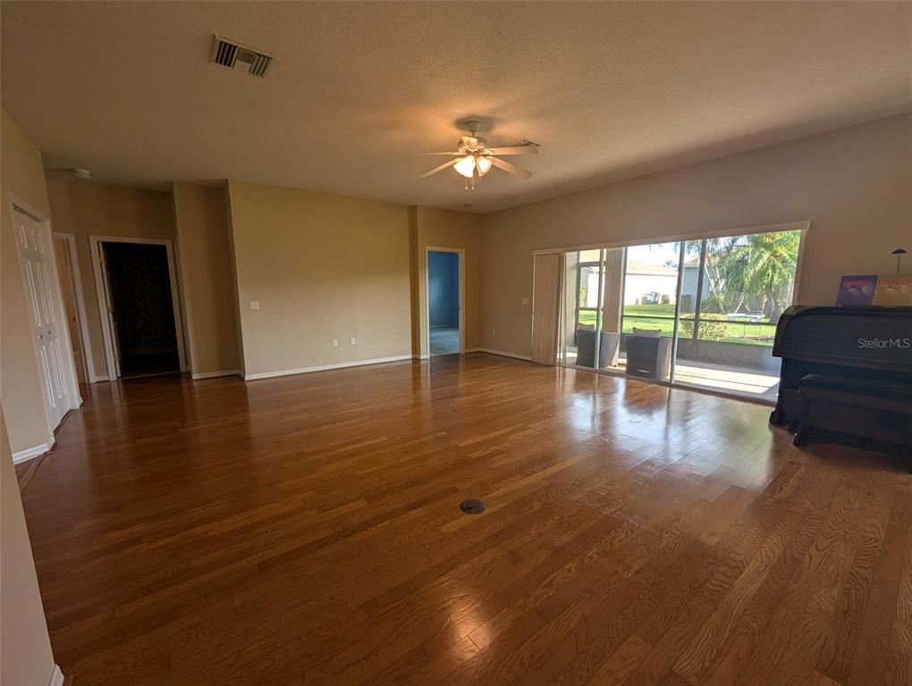 4124 Muirfield Loop Lake Wales, FL 33859 - Photo 8 of 29 a view of an empty room with wooden floor and a fireplace